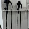 EV charging cables hung on white wall rack