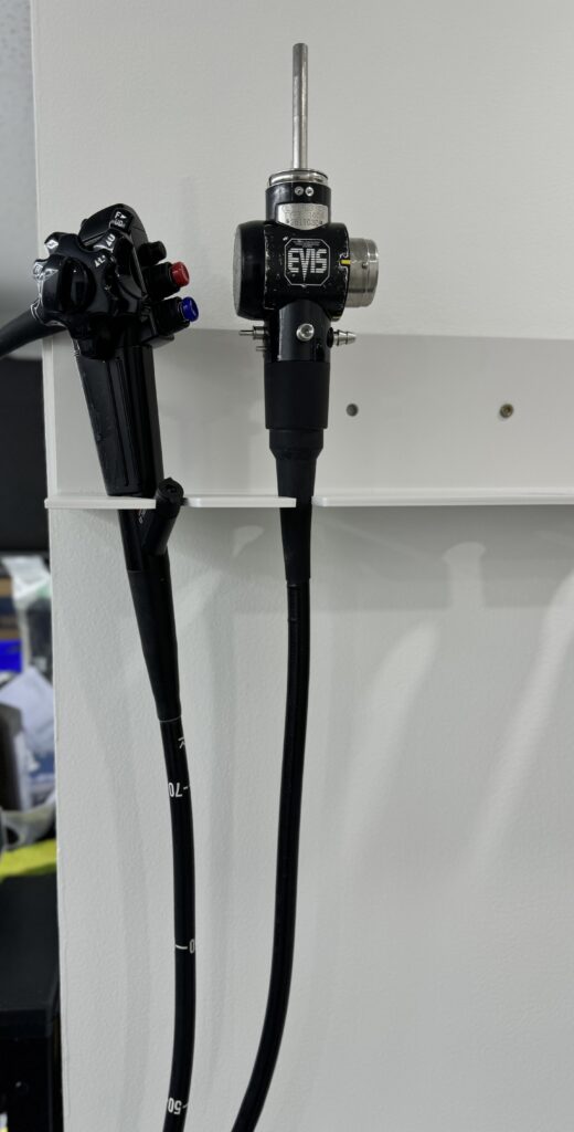 Industrial pilot valve and hydraulic hoses mounted on wall.