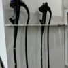 flexible endoscopes on wall-mounted rack.