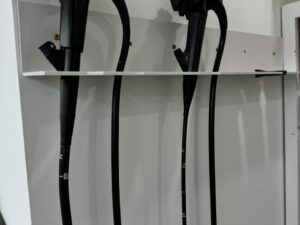 flexible endoscopes on wall-mounted rack.