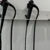 endoscopes mounted on a wall rack