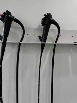 endoscopes mounted on a wall rack