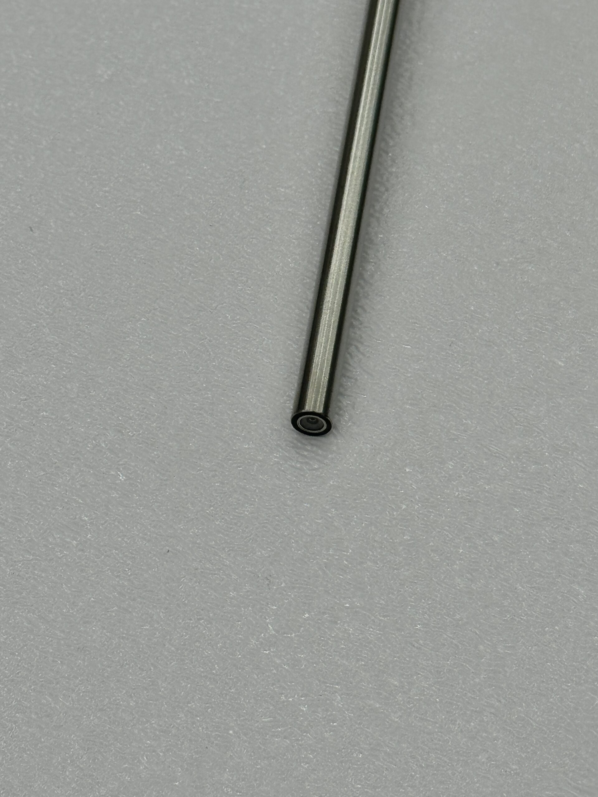 Close-up of a metal rod on textured gray background