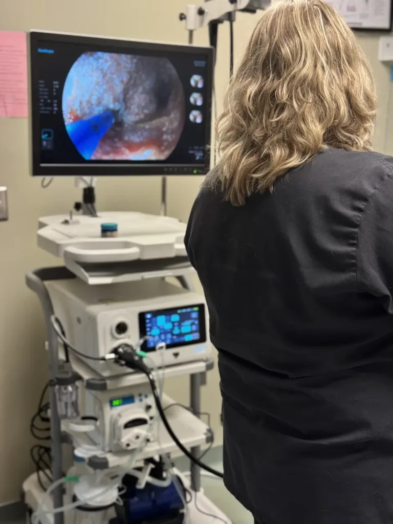 Doctor examining medical imaging on screen in clinic