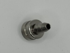 Metallic nozzle component on gray background