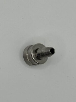 Metallic nozzle component on gray background